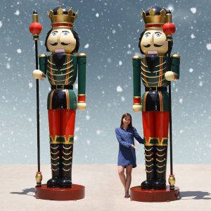 Pair of giant nutcrackers with woman
